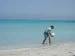 A kid on the beach wearing SPF 200