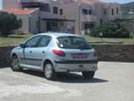 We were picked up at Porto Torres, Sardinia, by Carlo in his rented Peugot 206. Here it is parked in fron of our place at La Pelosa