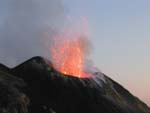 Stromboli erupts in a single big explosion about every ten or twenty minutes. You have to be lucky (or extremely patient) to catch it with a camera. Here it is dusk and we're on the trail. Hence the blurry shot.