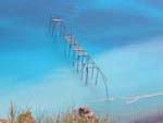 An abandoned loading structure at an old Lipari pumice quarry--note the floating masses of pumice near the shore.