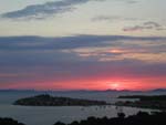 Sunset over the Adriatic, the ancient town of Primosten in the middle distance