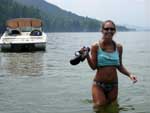 Robyn, leaving the boat anchored in Log bay and carrying her "hiking shoes"