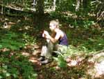 Robyn taking a break on the trail to shed her pack and eat a plum