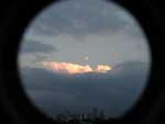 Moon and lit cloudtops over downtown