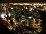 The southern tip of Manhattan - Battery Park in the foreground, Brooklyn and Manhattan Bridges at the upper right, the bright lights of Ground Zero at far left