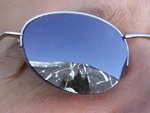 Is he contemplating the beauty of the mountain? Facing down his fear? Or is he just bored to death, waiting in the parking lot for the kids to get enrolled in ski school so he can hit the slopes?