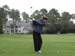 Robyn at the second tee, trying not to put the ball through one of Mom & Dad's windows