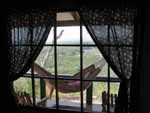 Looking out the window of our room - Robyn napping with the nature preserve in the background below